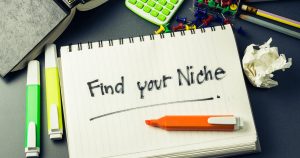 Foto de um caderno escrito "find your niche", representando como encontrar um nicho de mercado contábil