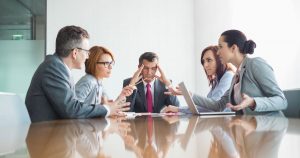 Imagem de uma sala de reunião com alguns colaboradores para implementar a gestão de conflitos na empresa